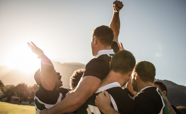 rugby players after the match celebrating 