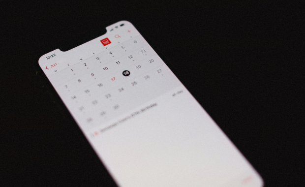 Phone displaying June calendar – peak season for stag do bookings in spring and summer.