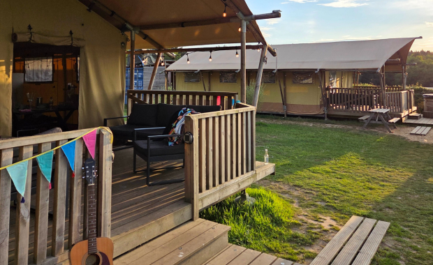 Group of friends enjoying a festival-style experience at StagFest™ – StagWeb's exclusive glamping experience.
